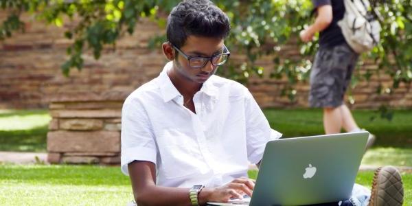 student working on their laptop