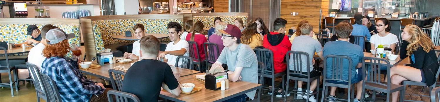 Students eating in the village center